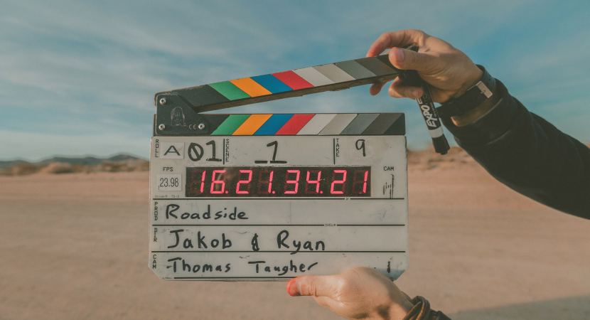 video script clapperboard with names on it in the dessert for filming