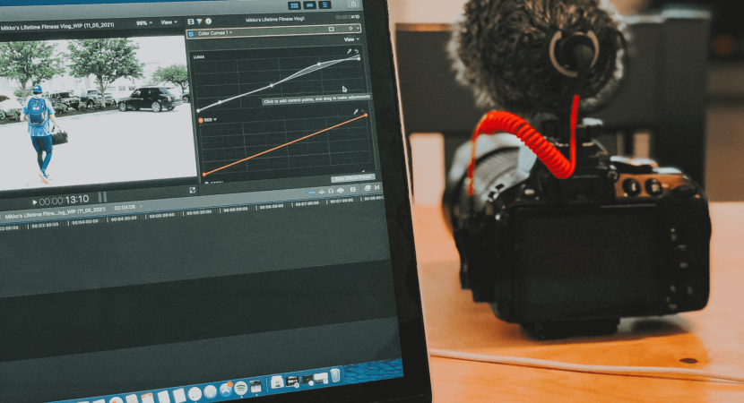 computer screen of video editing and a video camera with a microphone